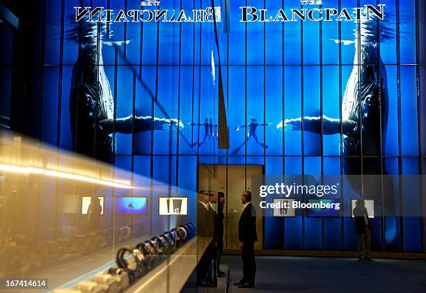 Visitors stand near the Blancpain booth, a luxury unit of Swatch Group AG, during the Baselworld watch fair in Basel, Switzerland, on Wednesday,...