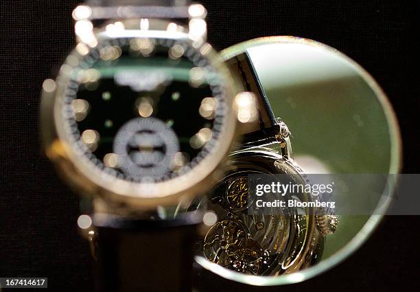The movement of a 5539G-001 wristwatch in white gold, manufactured by Patek Philippe SA, is reflected in a mirror as the watch sits on display during...