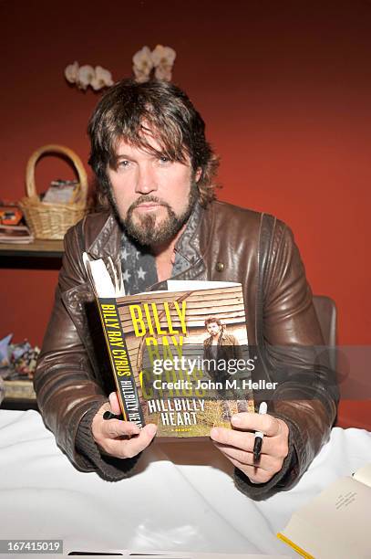 Singer Billy Ray Cyrus signs copies of his new book "Hillbilly Heart" at the New Roads School Moss Theater on April 24, 2013 in Santa Monica,...