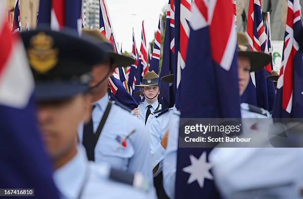 Members of the Australian Air Force Cadets hold Australian flags as they march during the annual Anzac Day march on April 25, 2013 in Melbourne,...