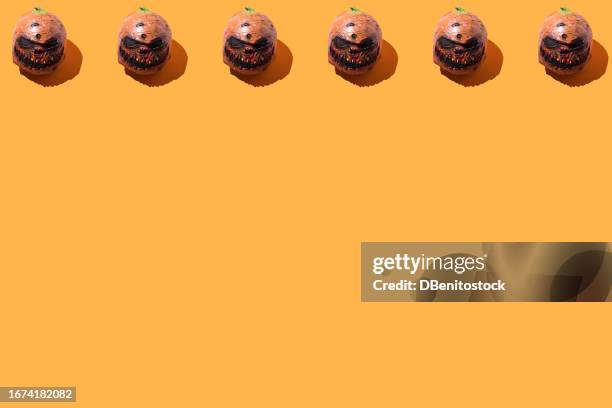halloween jack-o-lantern pumpkins pattern, on top, on orange background. concept of halloween celebration, days of the dead, scare, fear, deceased and saints. - ugly pumpkins fotografías e imágenes de stock