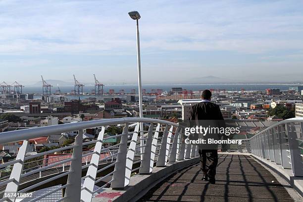 Pedestrian walks across a bridge toward the Woodstock residential district in Cape Town, South Africa, on Wednesday, April 24, 2013. South Africa's...