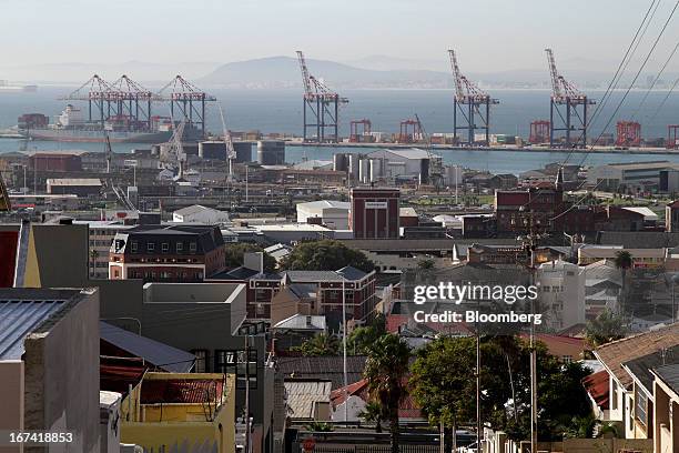 The residential district of Woodstock overlooks gantry cranes on the harbourside in the commercial port area of Cape Town, South Africa, on...