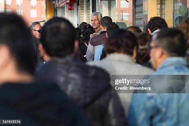 Jobseekers queue outside an employment office before opening in Madrid, Spain, on Thursday, April 25, 2013. Spanish unemployment rose more than...