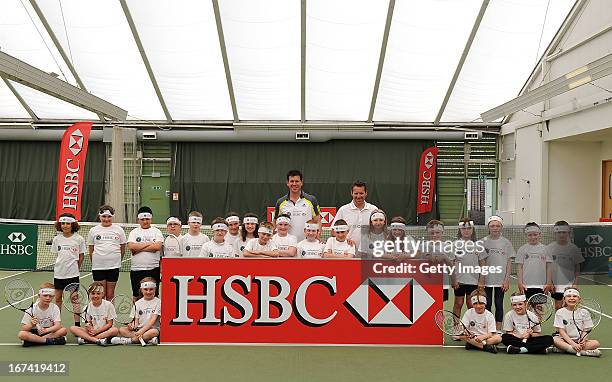 Former British No1 and HSBC Ambassador Tim Henman and Head Coach of the All England Tennis Club Dan Bloxham and the kids pose for photographs during...