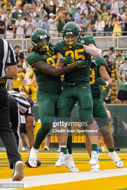 Baylor Bears running back Dawson Pendergrass and Baylor Bears tight end Kelsey Johnson celebrate a touchdown during the college football game between...