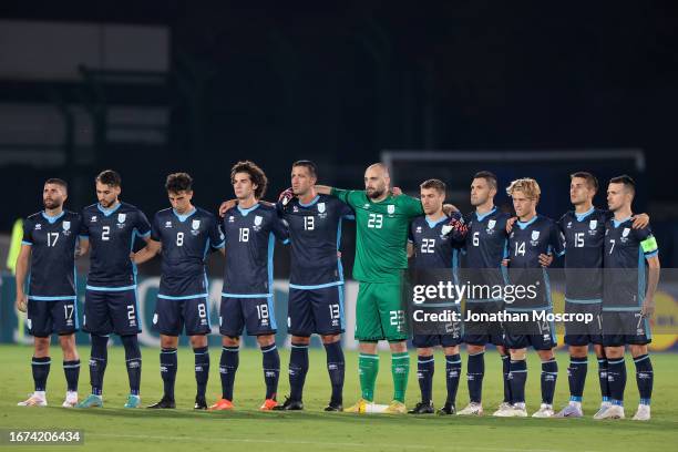 The San Marino team link arms as they observe a minute's silence in memory of the Morocco earthquake victims prior to the UEFA EURO 2024 European...