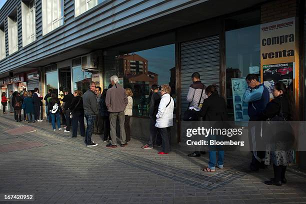 Jobseekers queue outside an employment office before opening in Madrid, Spain, on Thursday, April 25, 2013. Spanish unemployment rose more than...