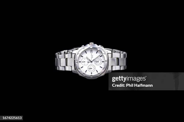 precious silver metal men’s chronograph wrist watch on black background - wristwatch imagens e fotografias de stock