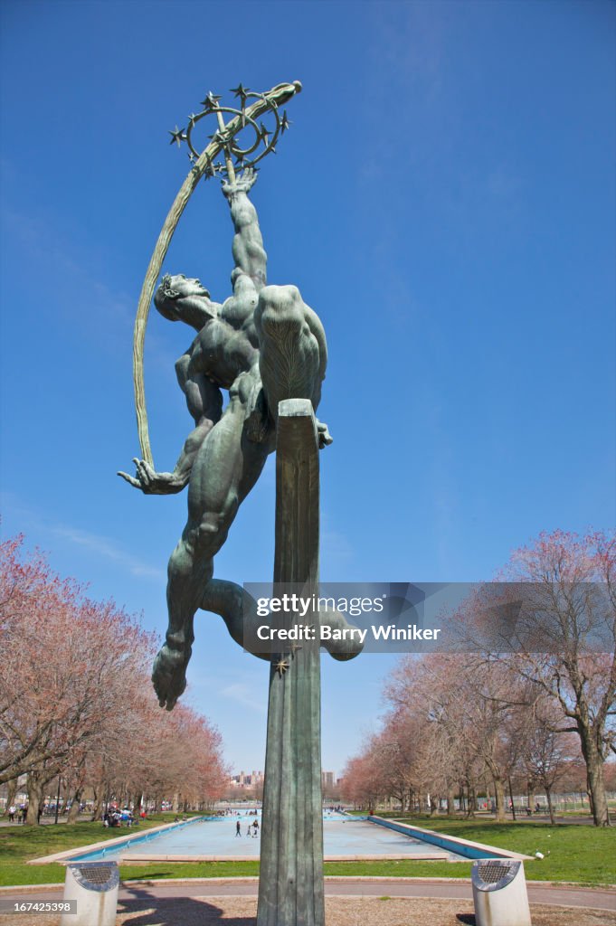 Green bronze sculpture of strong man in park