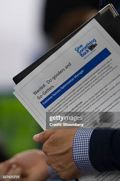 Job seeker holds paperwork while talking with a recruiter at the Spring LGBT Career Fair in San Francisco, California, U.S., on Wednesday, April 24,...