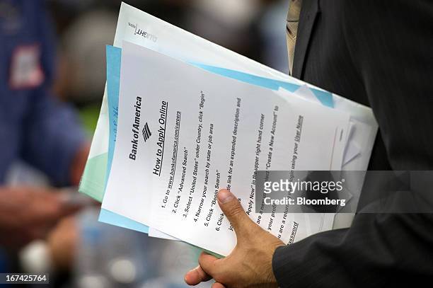 Job seeker holds Bank of America Corp. Paperwork while talking with a recruiter at the Spring LGBT Career Fair in San Francisco, California, U.S., on...
