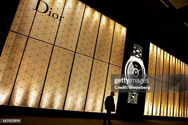 Visitor passes the Christian Dior SA booth during the Baselworld watch fair in Basel, Switzerland, on Thursday, April 25, 2013. The annual fair...