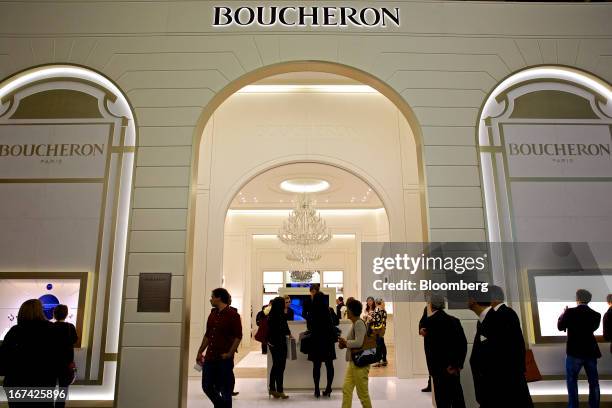 Visitors pass the Boucheron booth, a unit of PPR SA, during the Baselworld watch fair in Basel, Switzerland, on Thursday, April 25, 2013. The annual...