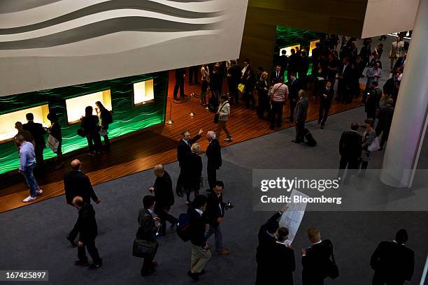 Visitors walk through a display hall during the Baselworld watch fair in Basel, Switzerland, on Thursday, April 25, 2013. The annual fair attracts...