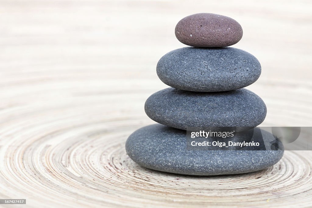 Balancing of pebbles on wooden background