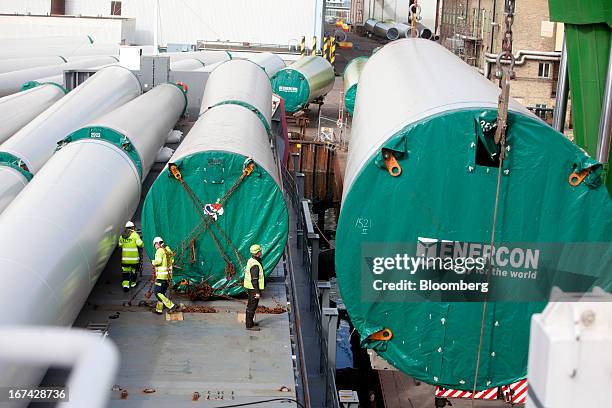 Employees secure windtower sections onto a shipping vessel at the Enercon Windtower Production AB plant in Malmoe, Sweden, on Thursday, April 25,...