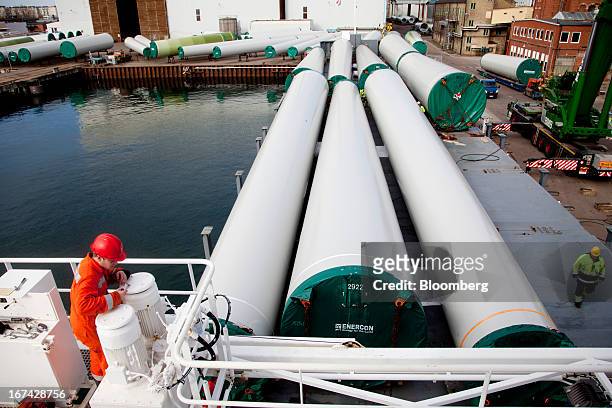 Employees secure windtower sections on a shipping vessel at the Enercon Windtower Production AB plant in Malmoe, Sweden, on Thursday, April 25, 2013....