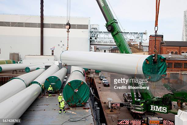 Employees secure windtower sections on a shipping vessel at the Enercon Windtower Production AB plant in Malmoe, Sweden, on Thursday, April 25, 2013....