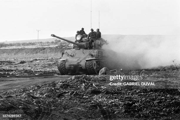 Israeli soldiers atop an US-made Super-Sherman tank move forward to the Syrian Golan Heights on October 17 during the 1973 ArabIsraeli War. On...