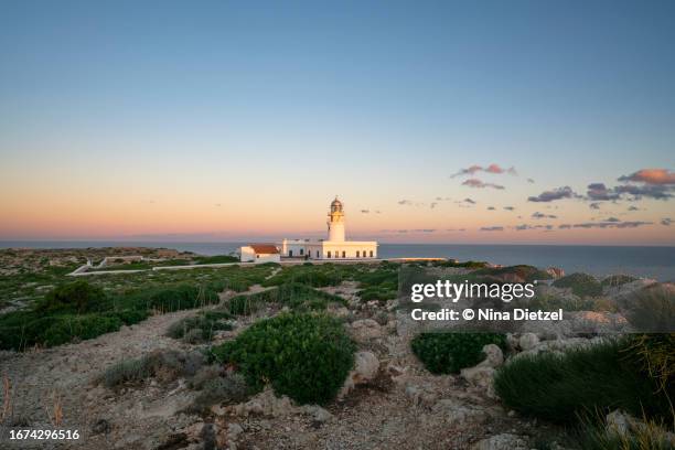 cap de cavalleria lighthouse at dawn, minorca - menorca stockfoto's en -beelden