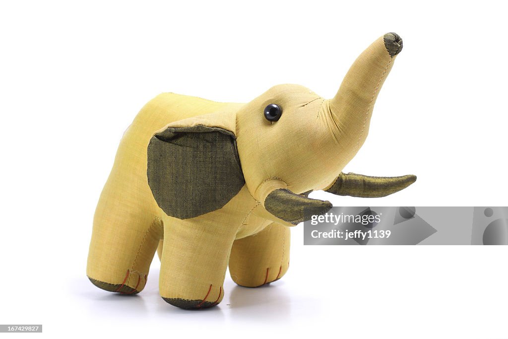 Thailand, Silk gold elephant doll isolated on white background