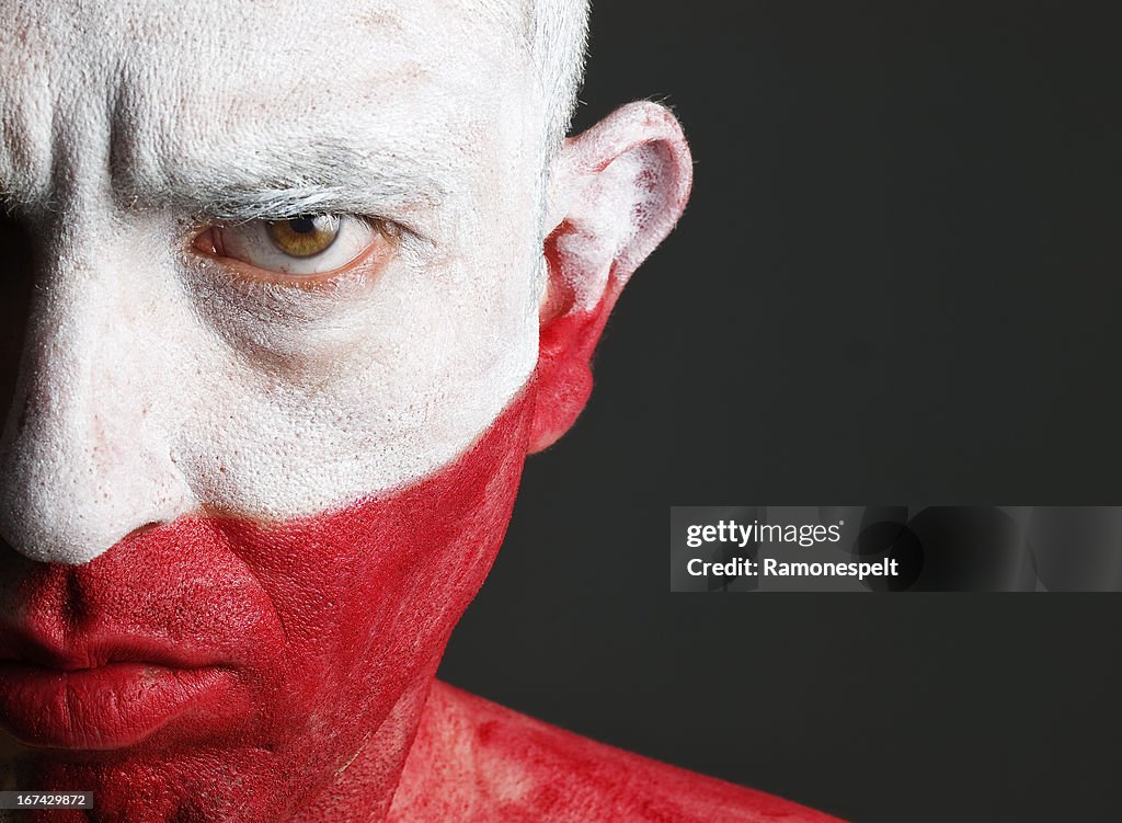 Man and his face painted with the flag of Poland