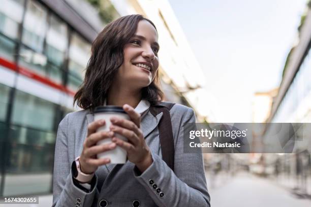 young professional in the urban hustle - takeaway coffee stock pictures, royalty-free photos & images