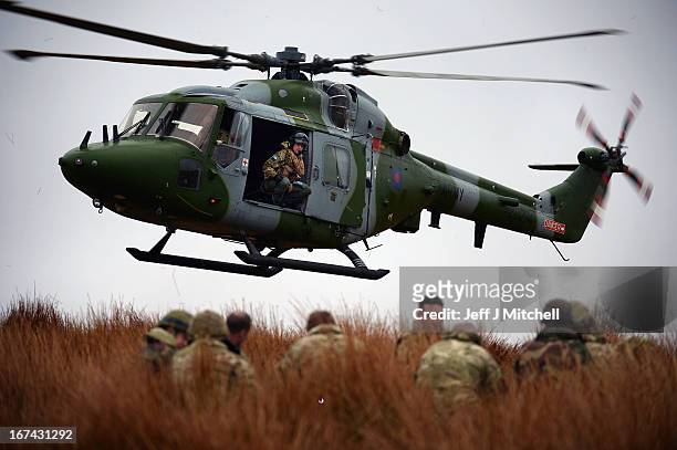 Helicopter hovers during a British And French Airborne Forces joint exercise on April 25, 2013 in Stranraer, Scotland. Exercise 'Joint Warrior' sees...