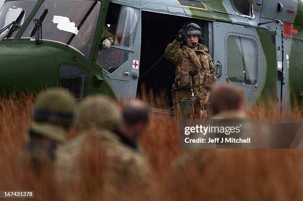 Soldier signals from the side of a helicopter during a British And French Airborne Forces joint exercise on April 25, 2013 in Stranraer, Scotland....