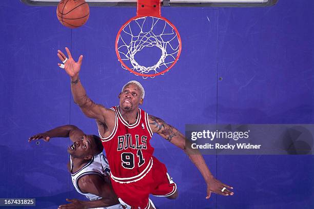 Dennis Rodman of the Chicago Bulls rebounds against the Sacramento Kings on February 1, 1996 at Arco Arena in Sacramento, California. NOTE TO USER:...