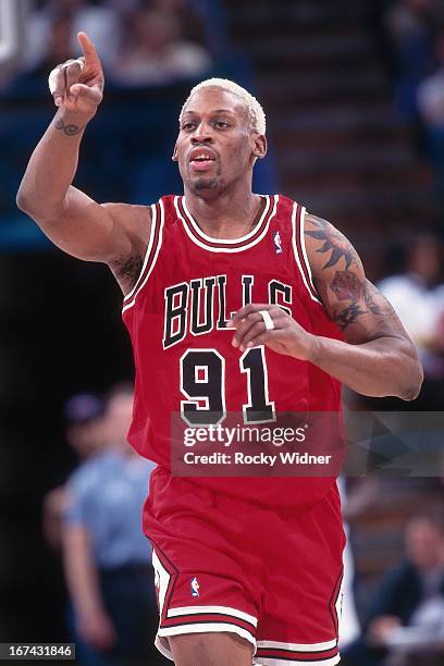 Dennis Rodman of the Chicago Bulls points against the Sacramento Kings on February 1, 1996 at Arco Arena in Sacramento, California. NOTE TO USER:...