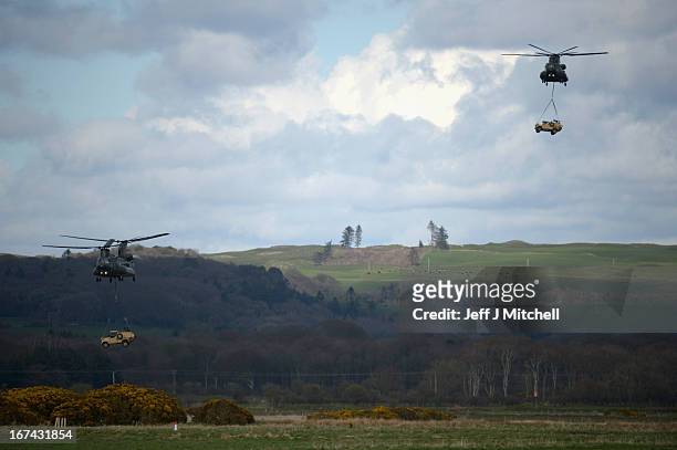 Two Chinook helicopters transport vehicles during a British And French Airborne Forces joint exercise on April 25, 2013 in Stranraer, Scotland....
