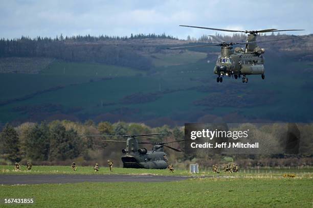 Two Chinook helicopters drop soldiers during a British And French Airborne Forces joint exercise on April 25, 2013 in Stranraer, Scotland. Exercise...