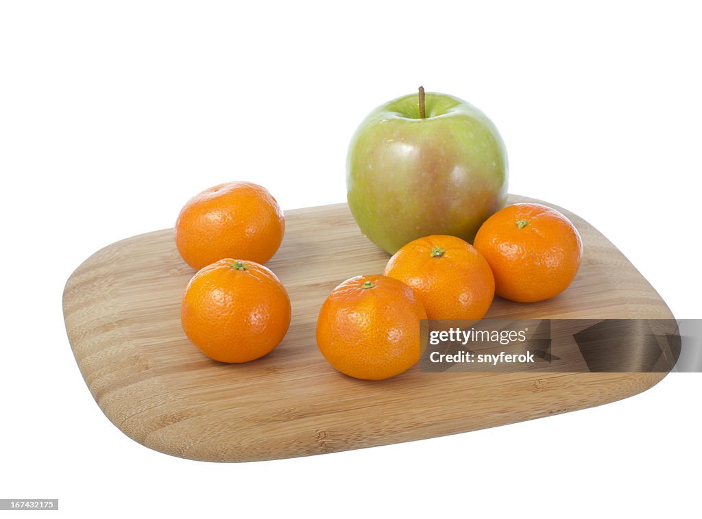 Fruits on cutting board.