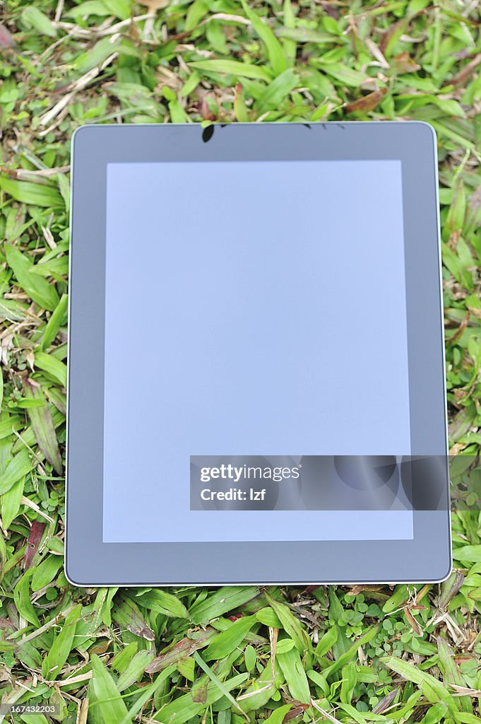 Tablet on green grass
