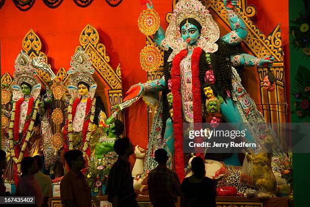 People admire a massive statue of the Hindu goddess Kali in a large neighborhood shrine in the New Market Square for the Kali Puja religious...