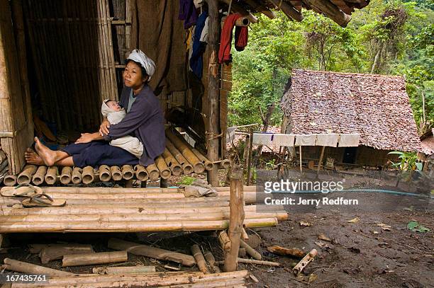 Year-old refugee mother of seven sits on the stoop with her three-week-old baby in the new arrivals section of the camp. They have been in the camp...