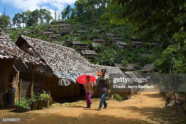 Young couple walks through Mae La Oon Refugee Camp, home to approximately 14,000. The camp is pitched on the sides of a very steep valley, and there...