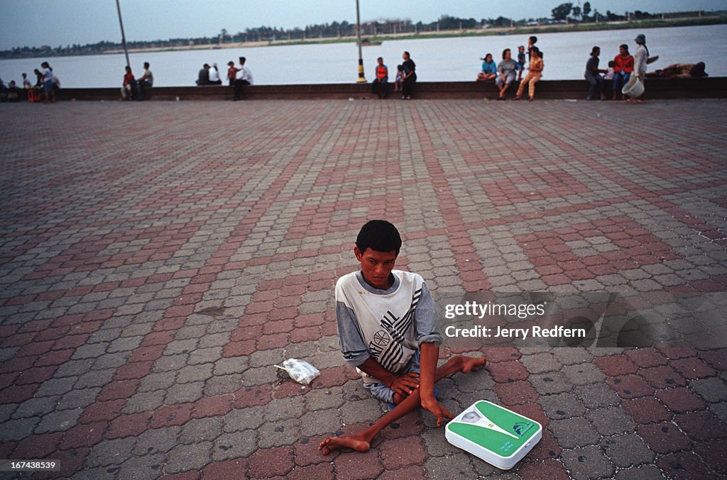 A young man, with what is probably polio, makes money...