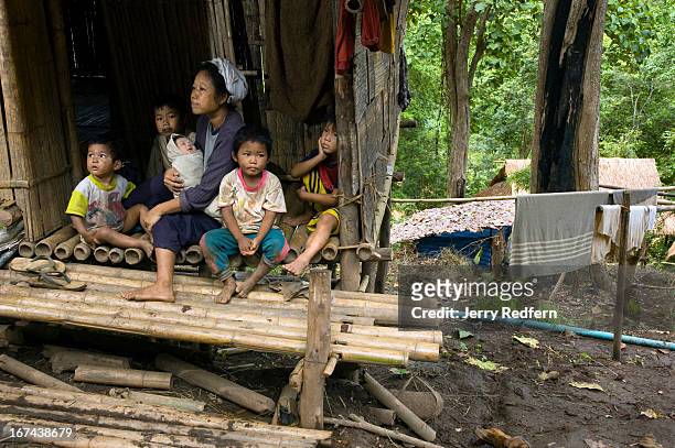 Year-old refugee mother of seven sits on the stoop with some of her children in the new arrivals section of the camp. They have been in the camp...