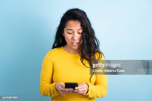 a sad woman while using the phone - angry people stock pictures, royalty-free photos & images