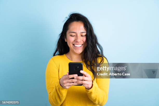 a happy woman while using the phone - beautiful woman shocked stock pictures, royalty-free photos & images