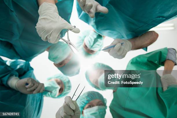 group of surgeons during surgery - bandage bildbanksfoton och bilder