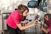 Automobile insurance adjuster inspecting damage to vehicle