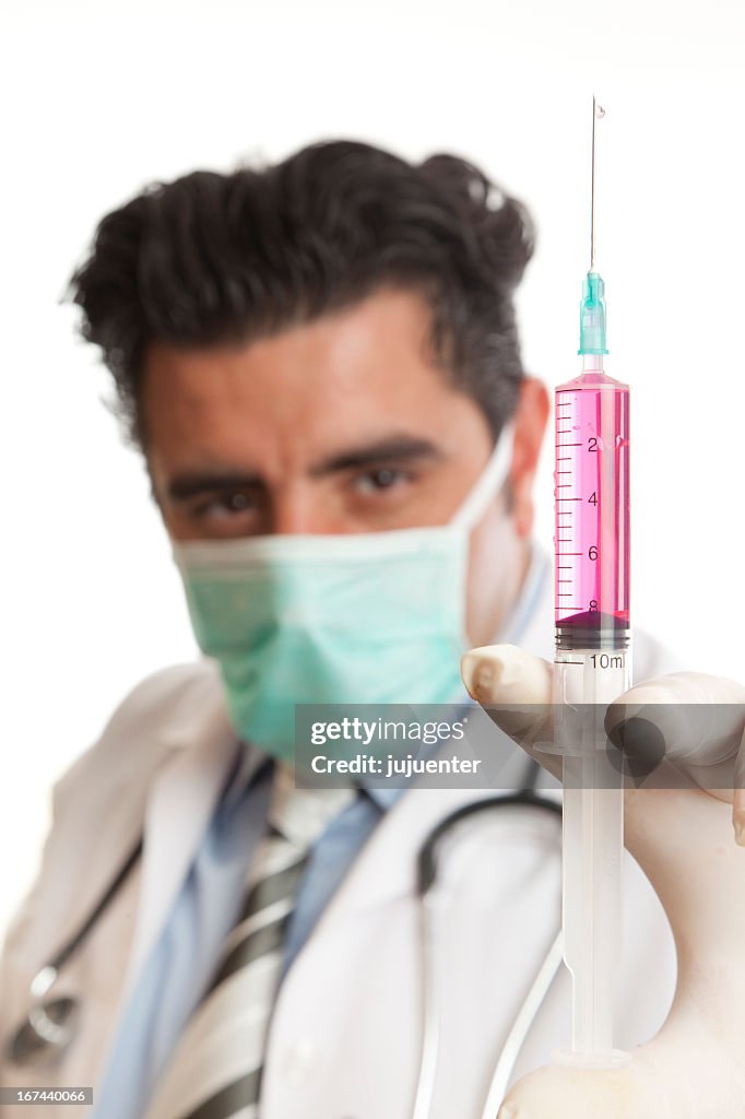 Surgeon holding syringe