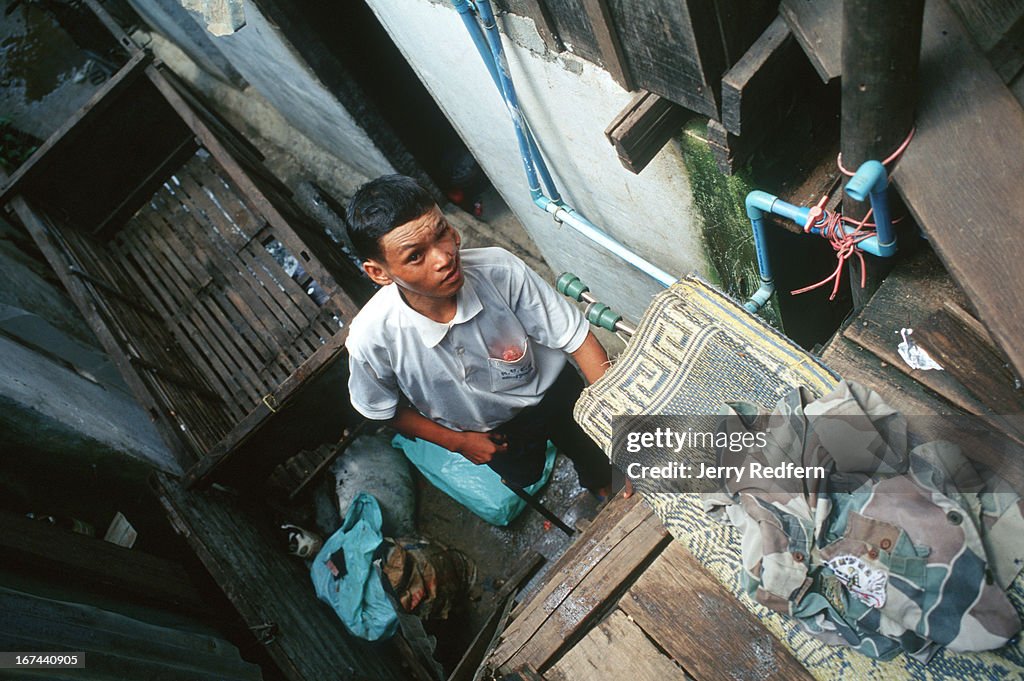 Bun Na removes the last of his possessions from the small,...