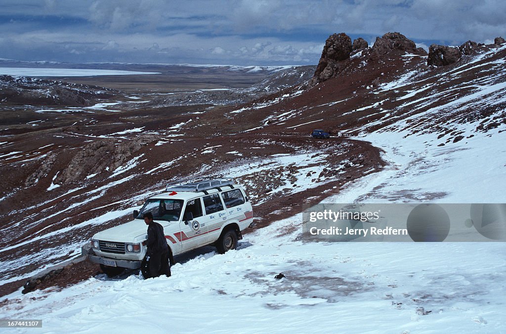 A tourist vehicle  is stuck in a snowdrift that blew in...