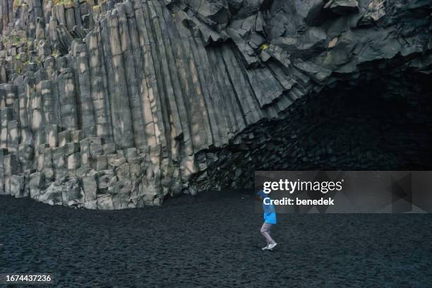 iceland hiking reynisfjara black sand beach - dark sand stock pictures, royalty-free photos & images