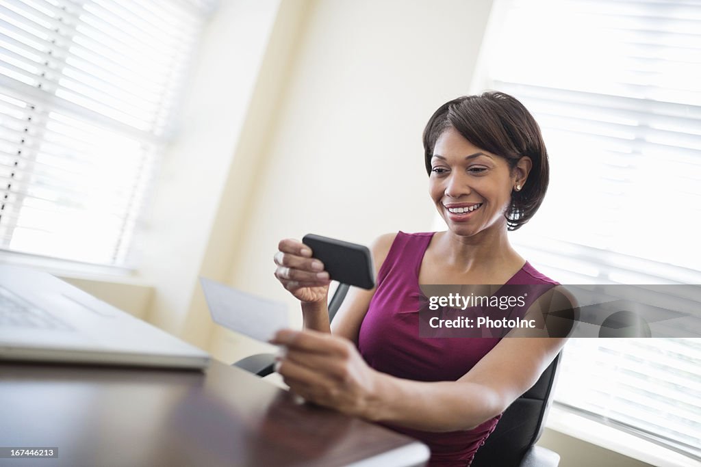 Businesswoman Depositing Check Through Smart Phone